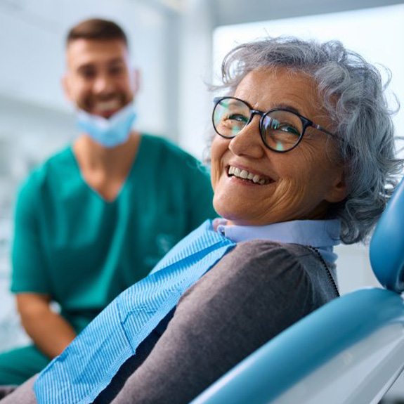 a patient smiling while visiting her dentist