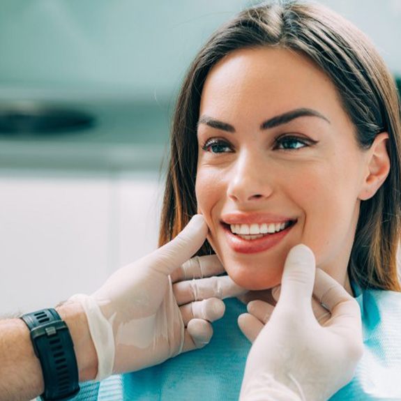 a patient getting her smile checked by her dentist