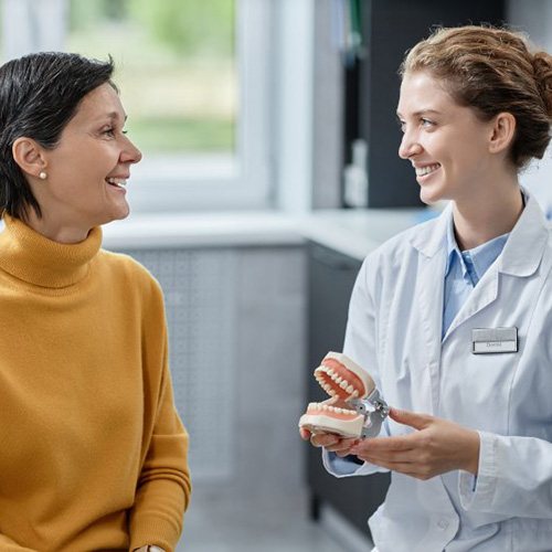 a patient and dentist smiling and talking